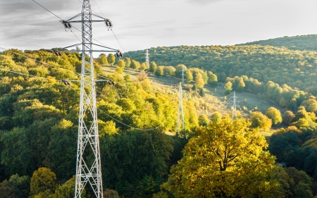 Beautiful autumn landscape at sunset with electrical power lines pillarsの写真素材