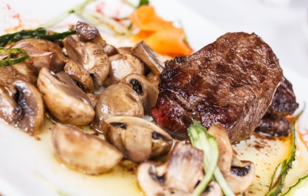 Beef steak with tasty mushrooms and truffle oilの写真素材