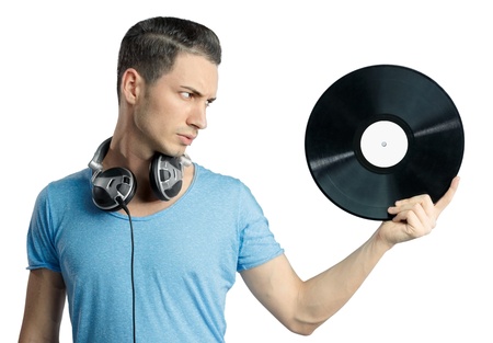 Young male having a serious expression while holding black vinyl in hand. Musical notes on gradient background.の写真素材