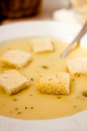 Mushroom cream soup served in white dish with small and tasty bread croutons.の写真素材