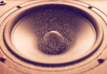 Large speaker doing a bass test while throwing white particles or dust in the air. Cross process edit.の写真素材