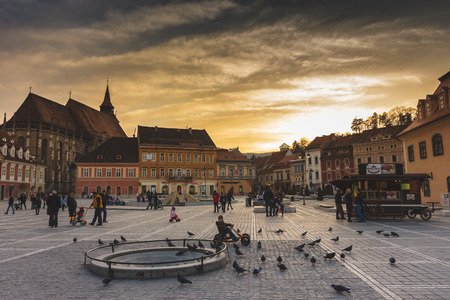BRASOV, ROMANIA - MARCH 1: Council Square on March 1, 2014 in Brasov, Romania. Beautiful sunset in the Old Town which includes the Black Church, Council Square and medieval buildings.のeditorial素材