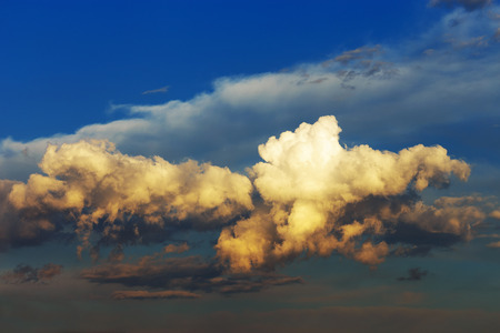 Fluffy clouds at sunset. Vintage effect.