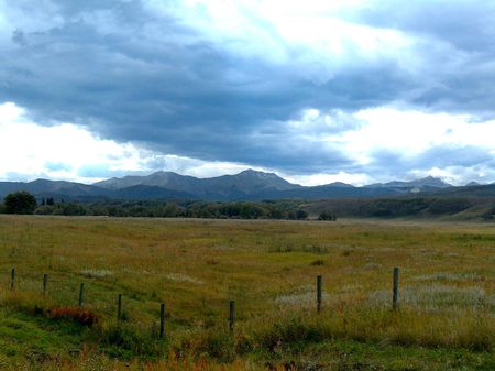 mountain range with foreground meadow pastureの写真素材