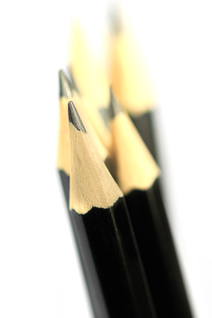 Macro close-up image of black pencils on white background with selective focus / shallow depth of fieldの写真素材