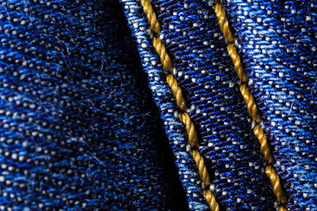 Macro close-up of denim jeans with fabric and seam