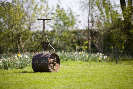 still life image garden lawn roller with at lot of hard work you to can have a nice flat lawn!の写真素材