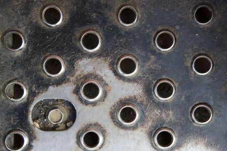 background image looking down at metal foot plate looking at shape and textuerの写真素材