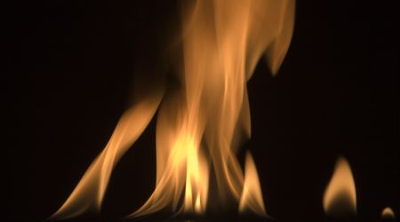image of red hot fire frozen in time against a black backgroundの写真素材