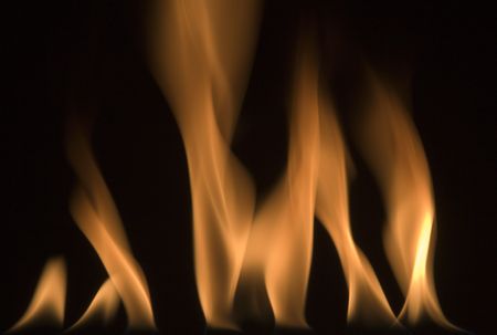 image of red hot fire frozen in time against a black backgroundの写真素材
