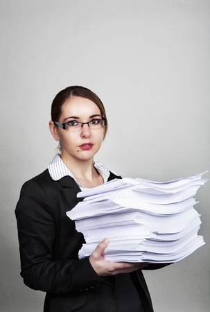 business woman holding lots of paper work to doの写真素材