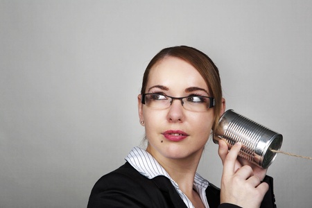 business womam making a call on a tin canの写真素材