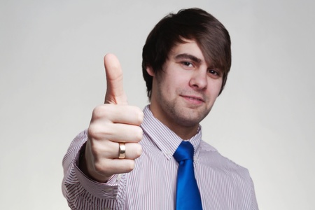 business looking man in a shirt and tie doing hand gestures, thumb upの写真素材
