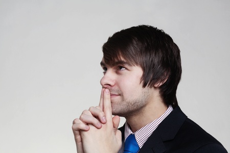 businessman looming up thinking to himselfの写真素材