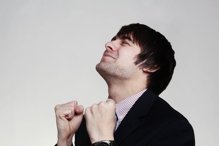 happy businessman with his arms up looking very pleased with himselfの写真素材