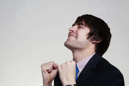 happy businessman with his arms up looking very pleased with himselfの写真素材