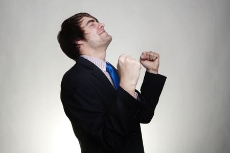 happy businessman with his arms up looking very pleased with himselfの写真素材