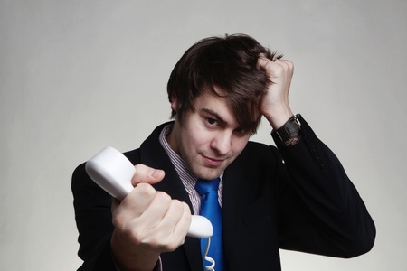 businessman scratching his head on the phoneの写真素材