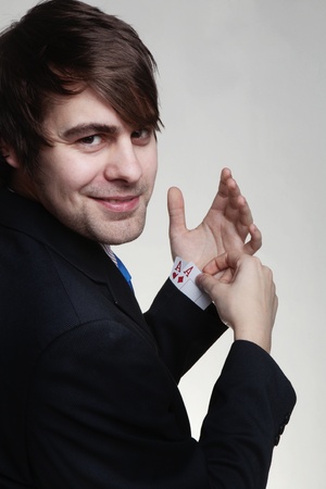 happy looking businessman and so he should be with two ace's up his sleeveの写真素材