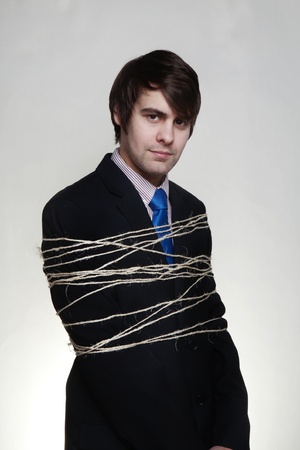 businessman tie up with string around his bodyの写真素材