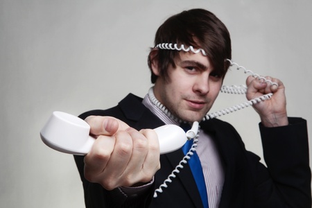 business man on the phone who got all wrapped up in the cord not the best of callの写真素材