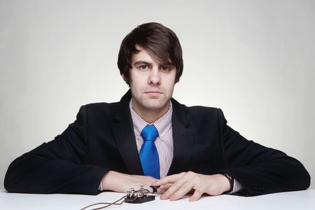 businessman using a morse code key to communicate with someone の写真素材