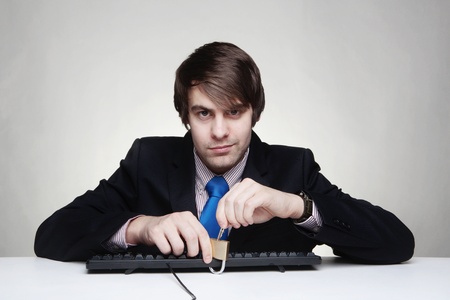 businessman with a padlock on his keyboardの写真素材
