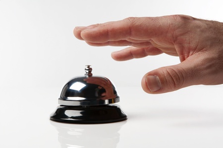 someone's hand pressing a service bell what could they wantの写真素材
