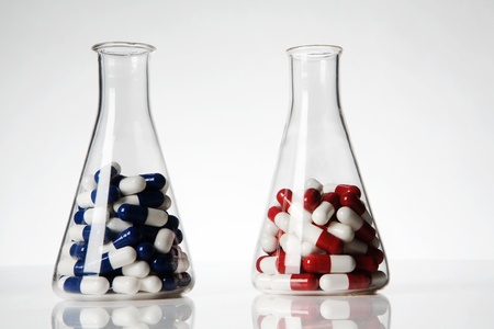 pills and tablets in laboratory beaker on a white backgroundの写真素材
