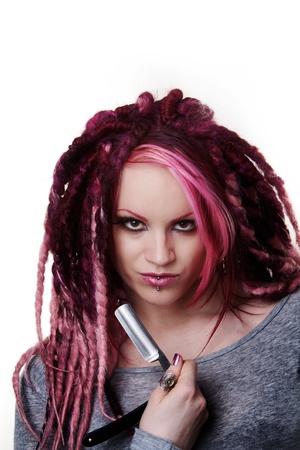 woman with dread lock hair holding a cut throat razor what is she going to do with itの写真素材