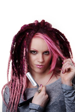 woman with dread lock hair holding a cut throat razor what is she going to do with itの写真素材