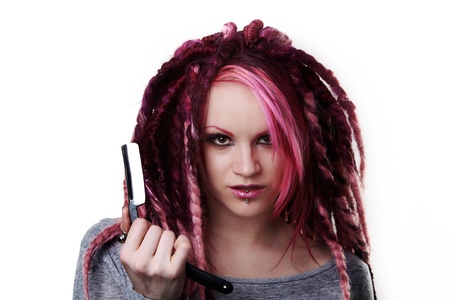 woman with dread lock hair holding a cut throat razor what is she going to do with itの写真素材