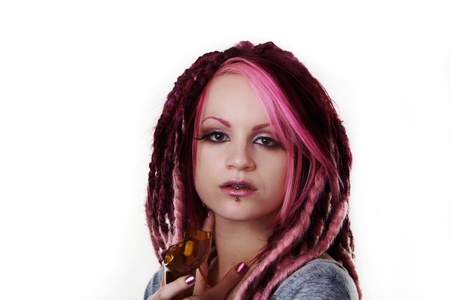 woman with dread lock hair holding a broken beer bottle what is she going to do with itの写真素材