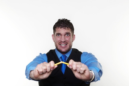 stressed out businessman breaking pencil. in need of stress managementの写真素材