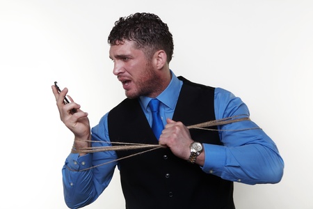 man with string around him caught up on a mobile phoneの写真素材