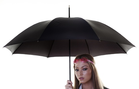 woman holding up a umbrella wearing swimming gogglesの写真素材