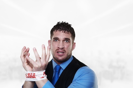 handsome man with his wrist taped up with fragile tape so he cant do any work and in need od some...