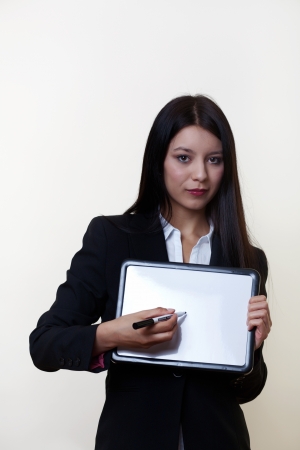 business woman holding up a small clean white board ready to write something onの写真素材