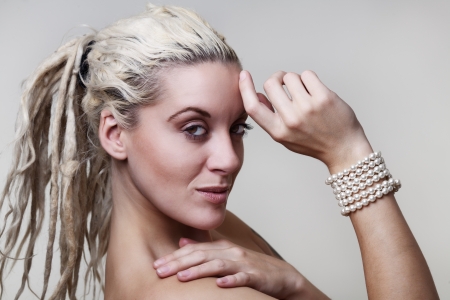 sexy woman with dreadlocks hair with pearls around her wrist の写真素材
