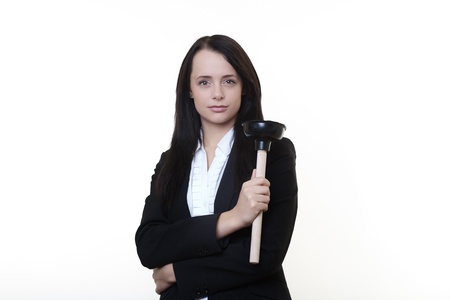 woman in a business suit holding a sink plunger it hard work but she ready to get her hand dirtyの写真素材