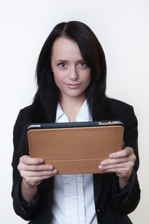 woman working hard on a touch screen pad keeping up to dateの写真素材