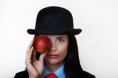 portrait image of sexy woman wearing a suit with bowler hat based around the painting of Rene Magritte の写真素材