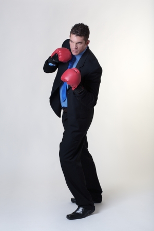 business man wearing boxing glover ready to take any job onの写真素材