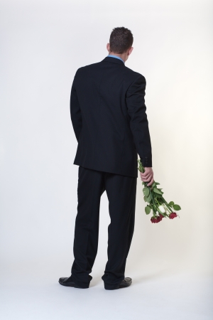 business man trying to give someone flowersの写真素材