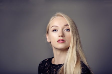 young woman close up portrait shot in the studio red lipstick and blonde hair looking at cameraの写真素材