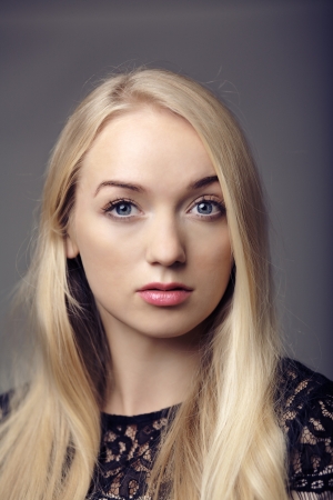 young woman close up portrait shot in the studio red lipstick and blonde hair looking at cameraの写真素材