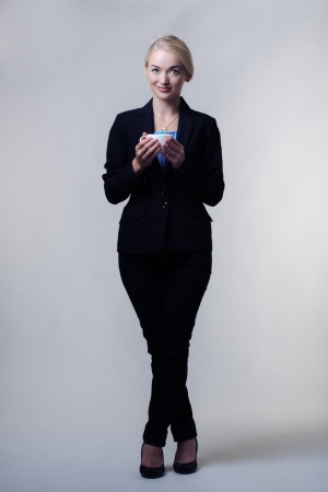 young business woman drinking tea from a china cupの写真素材