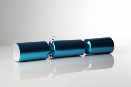 single christmas crackers on white reflective backgroundの写真素材