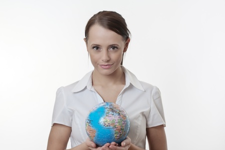 woman holding up a jigsaw globe puzzle の写真素材
