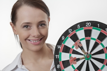 Businesswoman  holding up a dart board の写真素材
